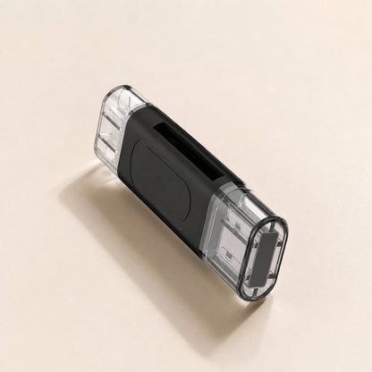 Quickslot – Black dual-ended card reader with clear caps on both plugs, seen at an angle with its card slot showing
