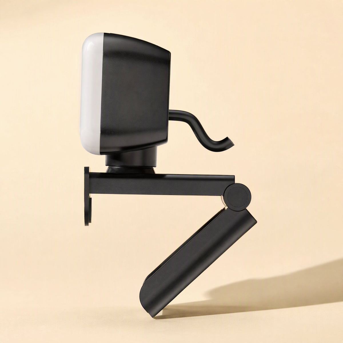 Screenface – Opposite side view of the webcam showing the folding clip arm and short cable, light panel facing left
