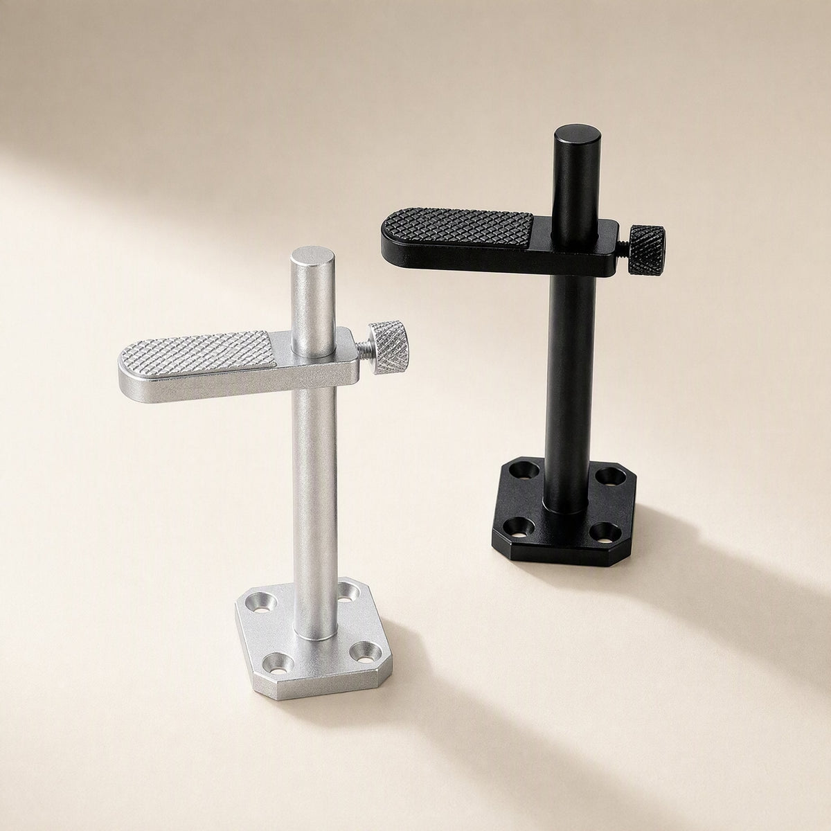 Alloyledge Aluminum Alloy Graphics Card Stand in silver and black side by side on a cream backdrop