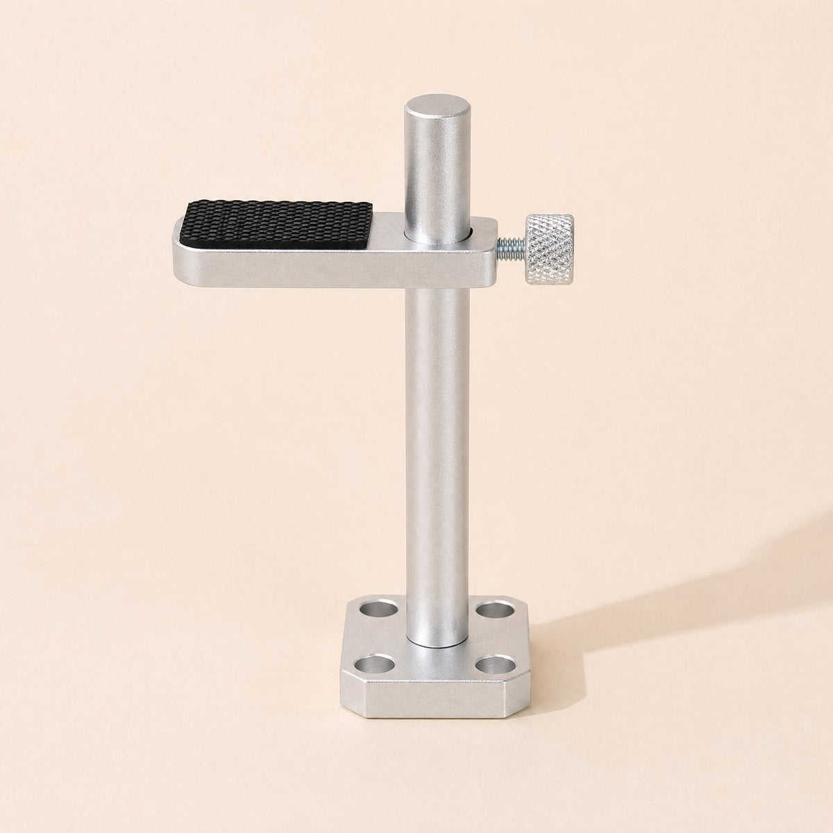 Alloyledge – Silver bracket with black textured rubber pad and four mounting holes in the base, front view