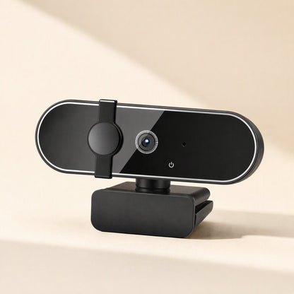 Pixelsharp 4K USB Computer Camera in black, angled front view with sliding privacy cover on a cream background