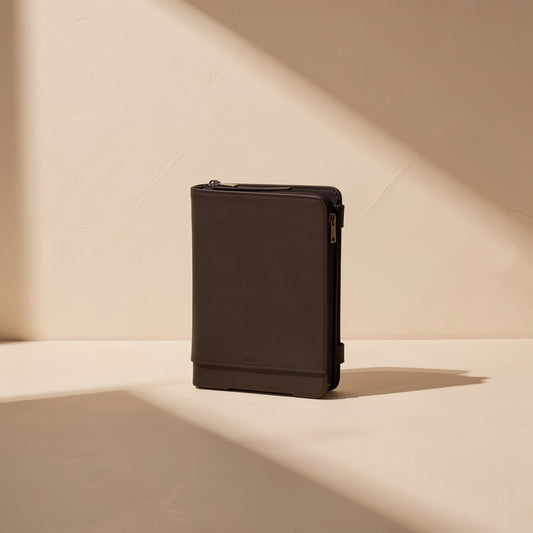 Silvertap Gaming Finger Sleeves – brown zippered case with a leather-look finish standing upright in angled sunlight