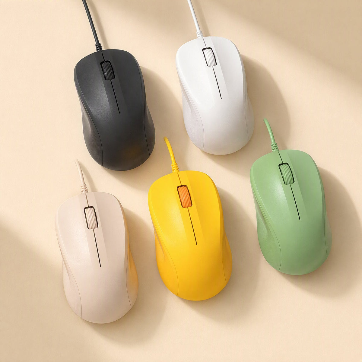 Deskcursor – Five wired mice in black, white, green, yellow and beige-pink arranged on a cream background