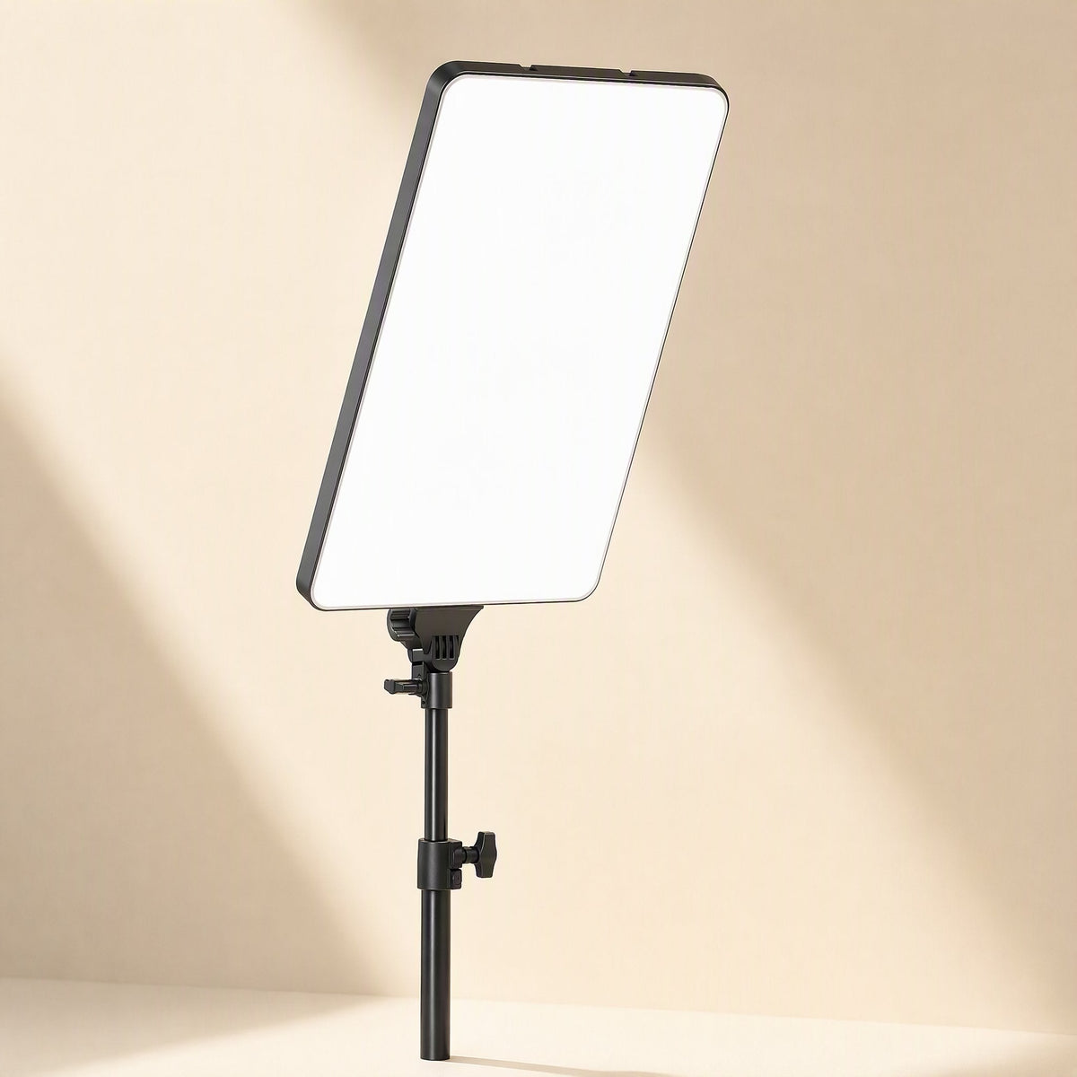 Softbeam – Rectangular fill light panel on a black telescoping pole with adjustment knobs, in soft diagonal light