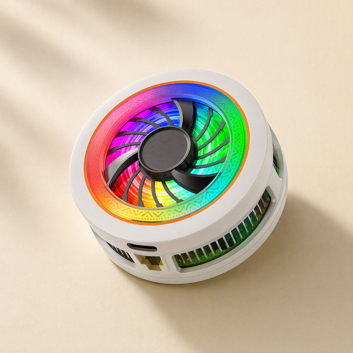 Phonechill – Close three-quarter view of the white cooler with USB-C port, side vents and rainbow LED ring on a cream