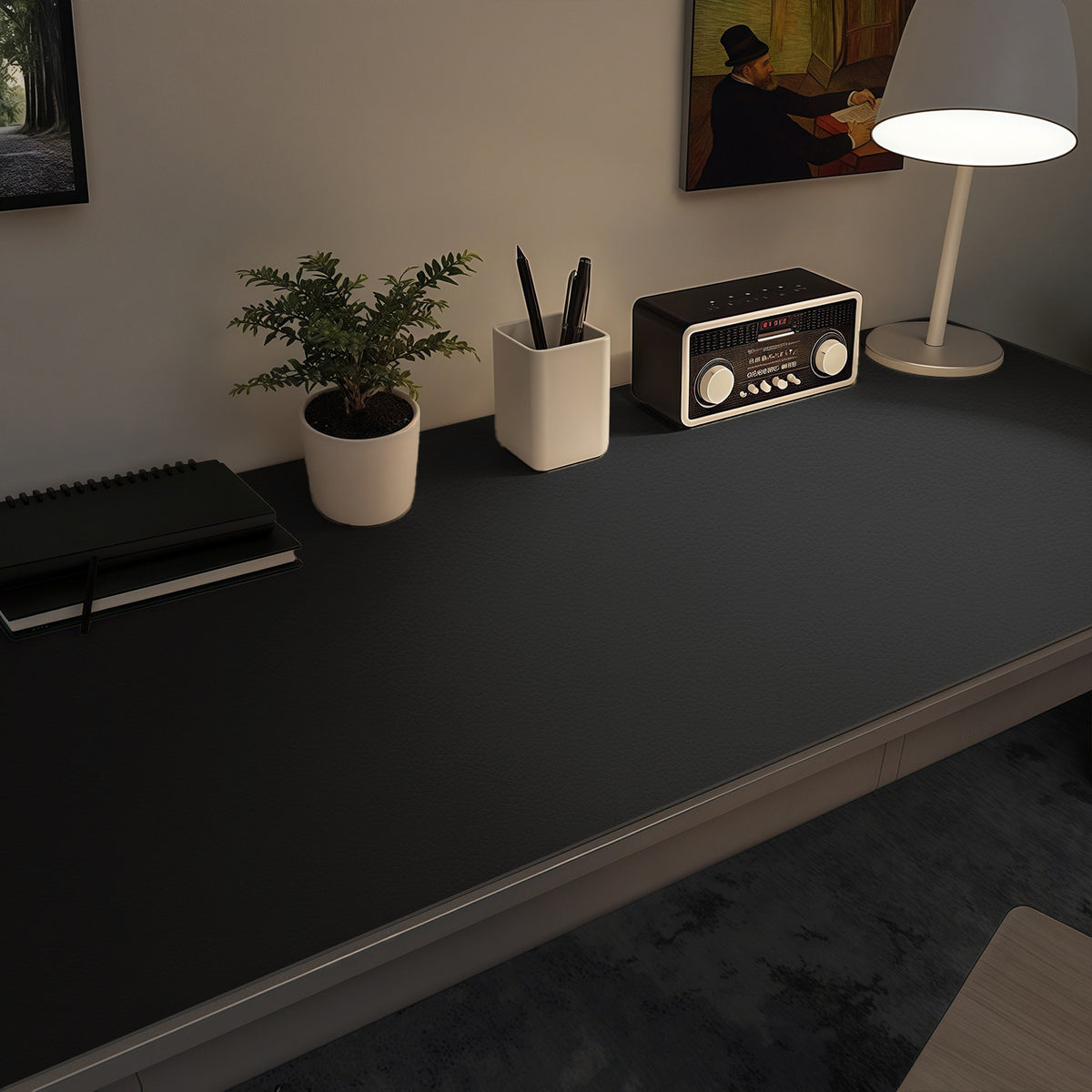 Matloom Leather Desk Mat in extra large black covering a desk with a plant, pen cup, radio and lamp
