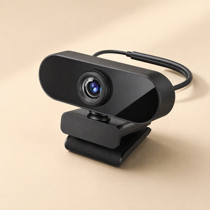 Viewbeam – Webcam with its USB cable curving behind it, standing on a folded black clip stand against a warm beige background