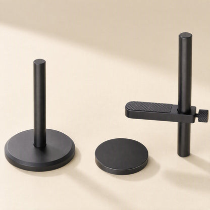 Alloybrace – Black bracket separated into pieces: pole on base, loose magnetic disc, and arm with textured pad