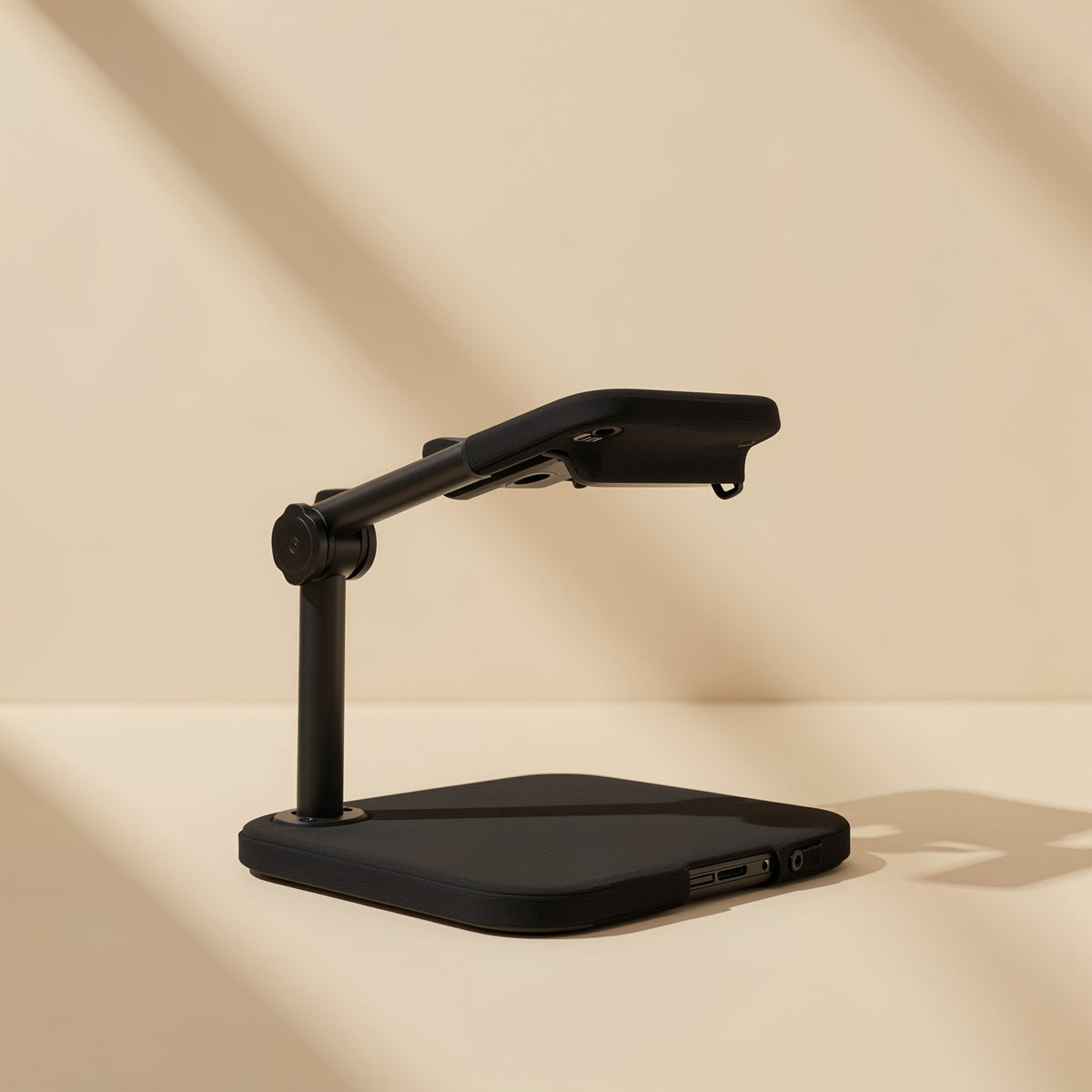 Streamstead – Black stand with a flat square base and arm angled over it, shown from a low side view