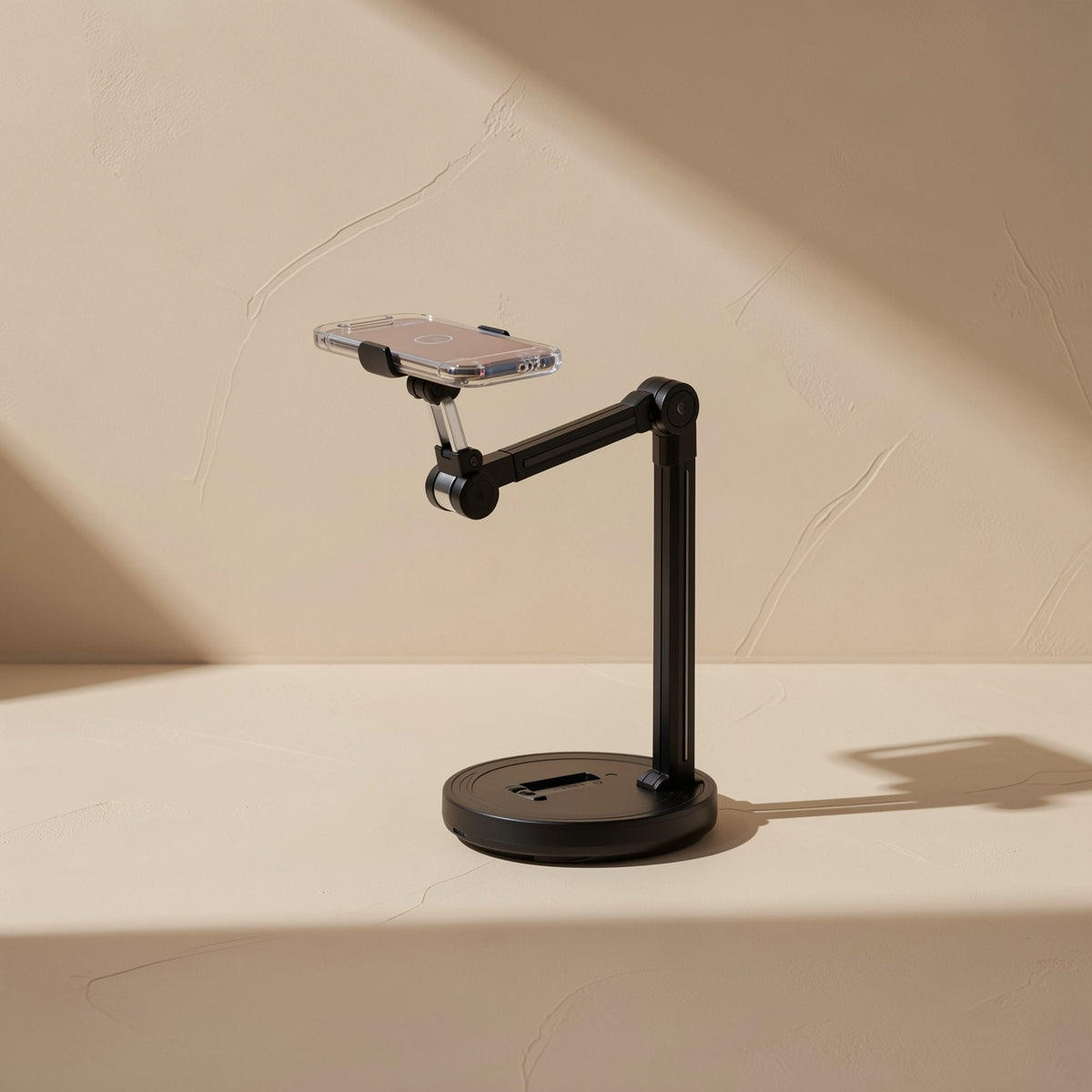 Streamstead – Side view of the black stand with a clear-cased phone held out on a bent arm over a round base