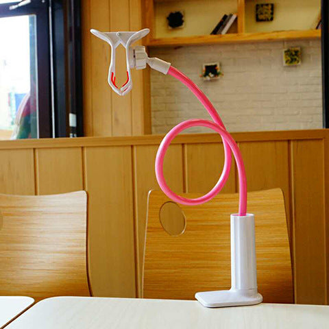 Coilrest – Pink flexible-arm stand with white clamp base and empty phone holder, clipped to a restaurant table
