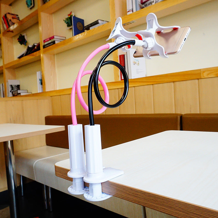 Coilrest Table Clamp Phone Stand – two clamp stands, pink and black, holding a phone above a table edge in a café