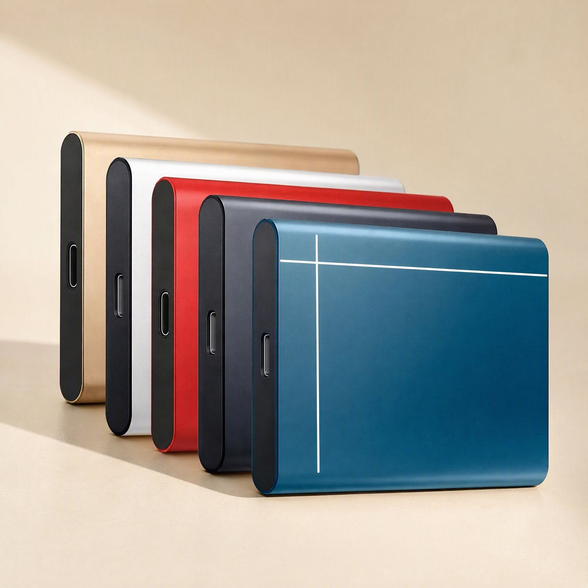 Metadrive Metal Mobile Solid State Drive in gold, white, red, black and blue, lined up side by side