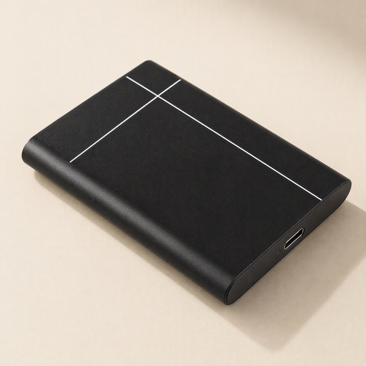 Metadrive – Black drive lying flat at an angle, with white line pattern on top and USB-C port at the front edge