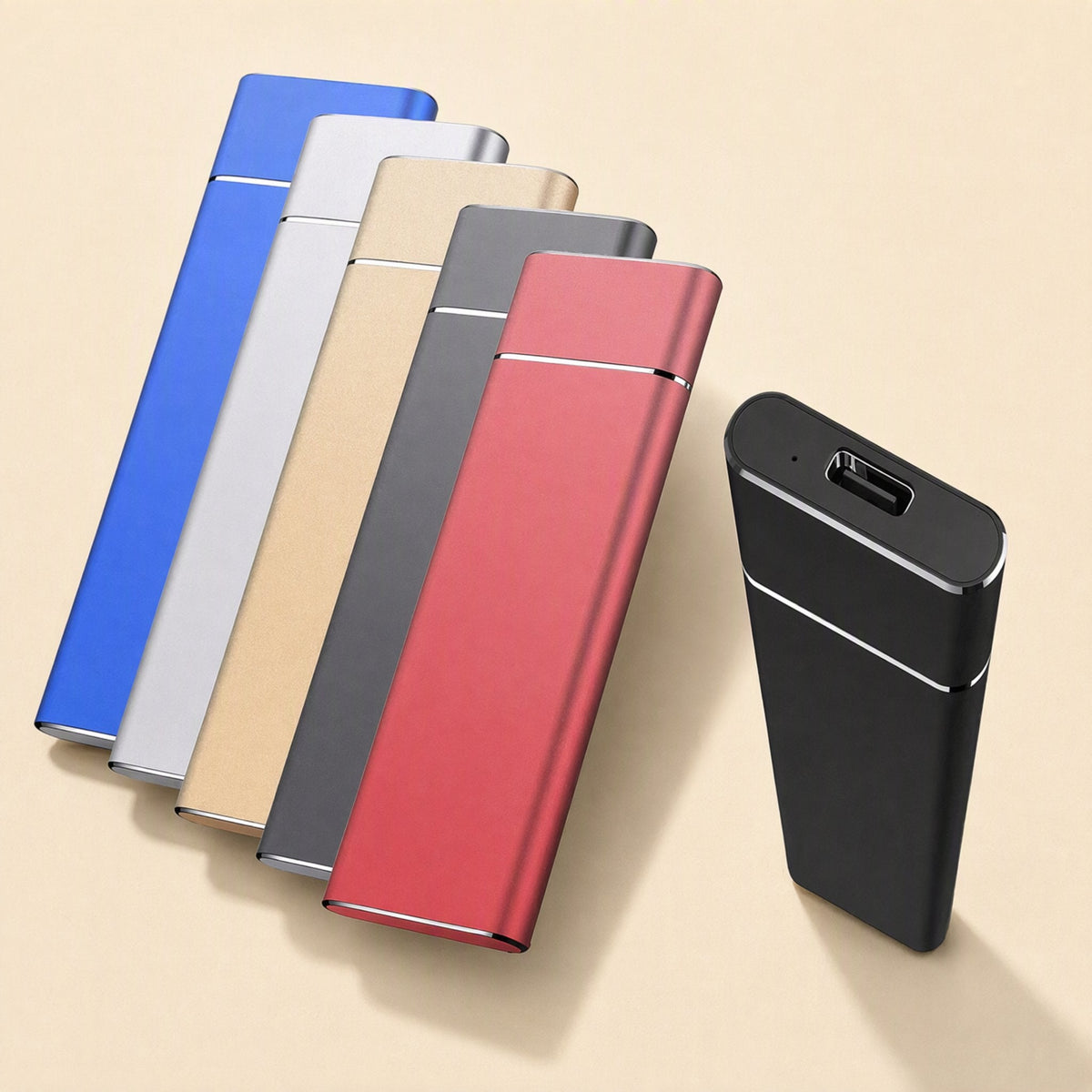 Pocketdrive External Solid State Drive in blue, silver, gold, gray and red beside a black unit with USB-C port
