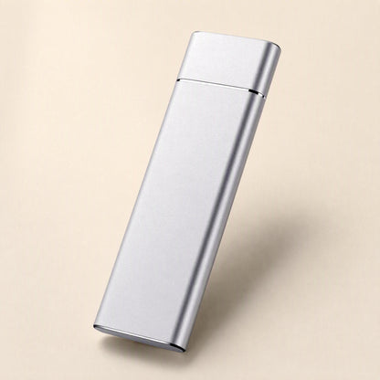 Pocketdrive External Solid State Drive – silver slim rectangular drive angled upright on a peach backdrop with a soft shadow
