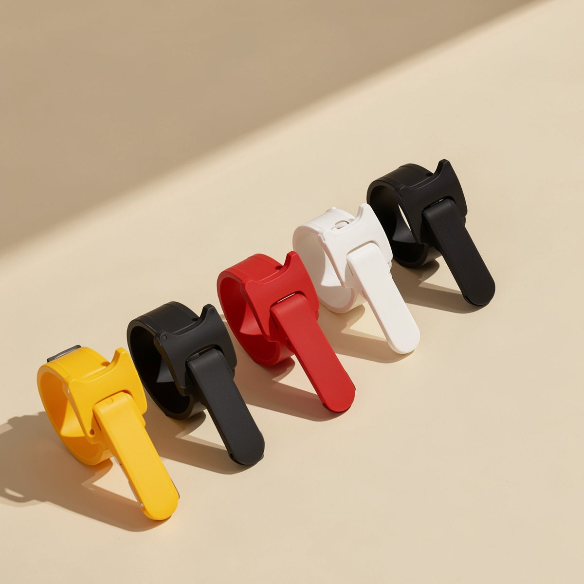 Colortie Nylon Cable Ties in yellow, black, red, white and black, lined up on a cream surface
