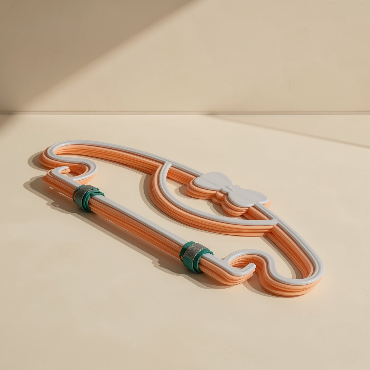 Two green and gray Colortie cable ties binding an orange and white cord loop with a bow detail