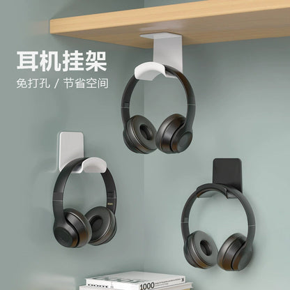 Earcradle – Three headphone stands mounted under a shelf and on a corner wall, each holding black headphones