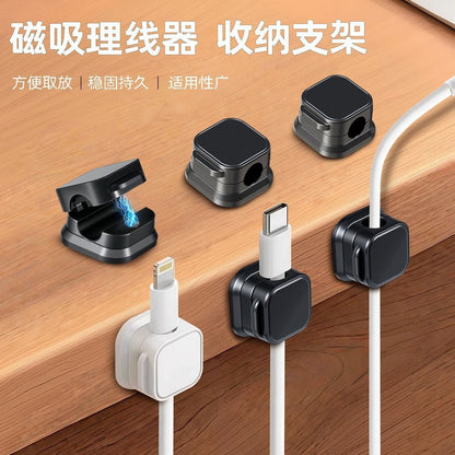 Magnetclip Magnetic Cable Management Clip in black and white on a wooden desk holding Lightning and USB-C cables