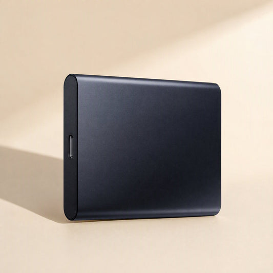 Alloybyte – Black aluminum portable drive standing on its edge against a beige backdrop, USB-C port on the narrow side