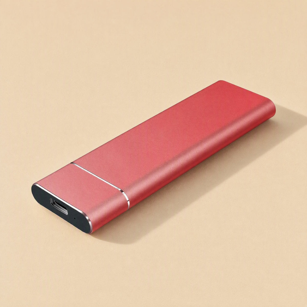 Roamdrive Portable Solid State Drive – red metal portable SSD at a three-quarter angle showing the USB-C port and seam line