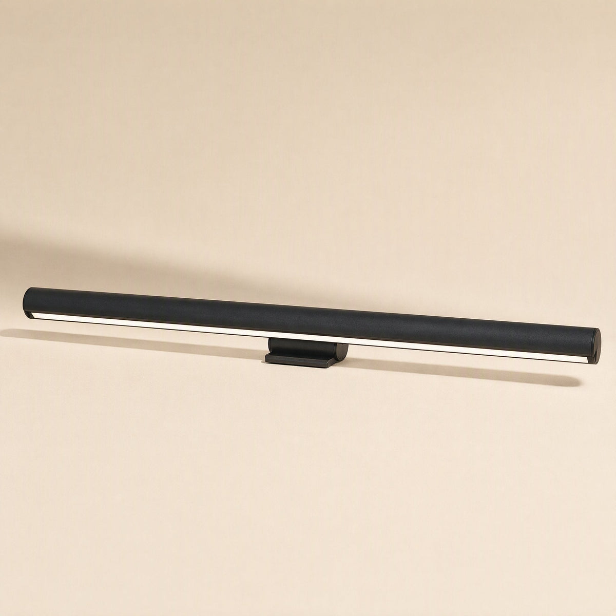 Screenlamp Metal Computer Monitor Light, a slim black cylindrical bar with a small clip mount on a beige background