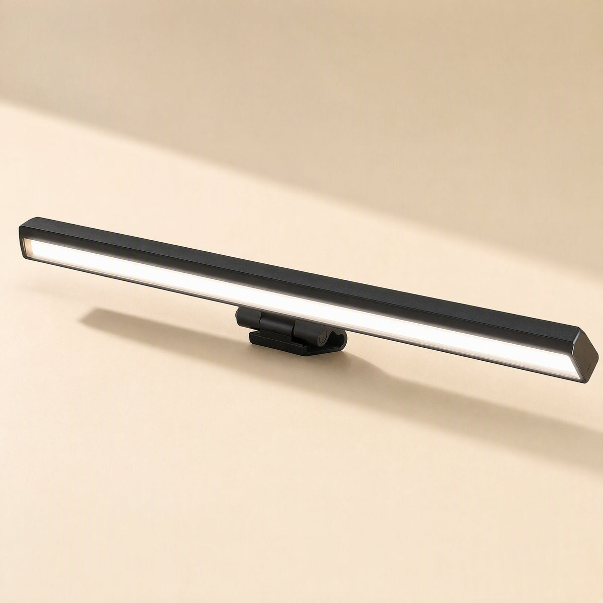 Screenlamp – Black rectangular monitor light bar with a hinged clip, shown from a front angle with its glowing diffuser lit
