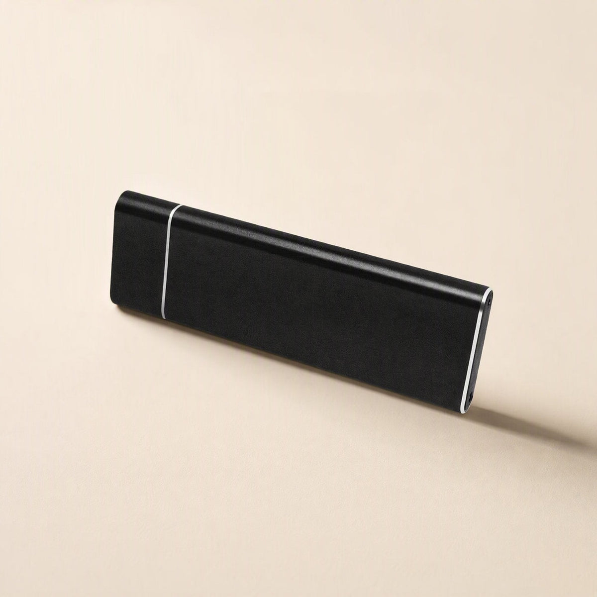 Drivevault – Black slim metal portable drive standing on its long edge, showing the silver band near one end