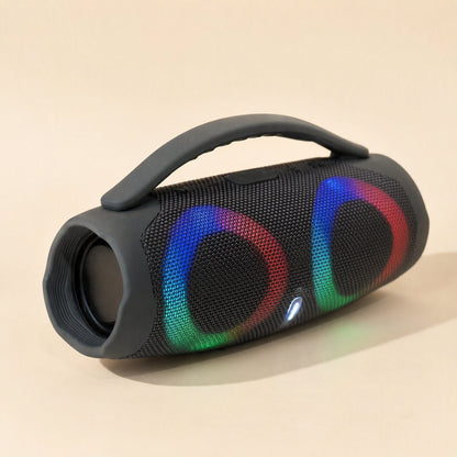 Portatune – Grey speaker with carry handle lying on its side, showing the open end and rainbow RGB rings