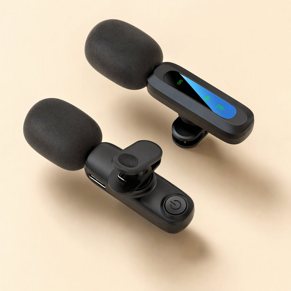 Livevoice – Two lavalier transmitters from above, one showing a power button and clip, the other a glowing green status