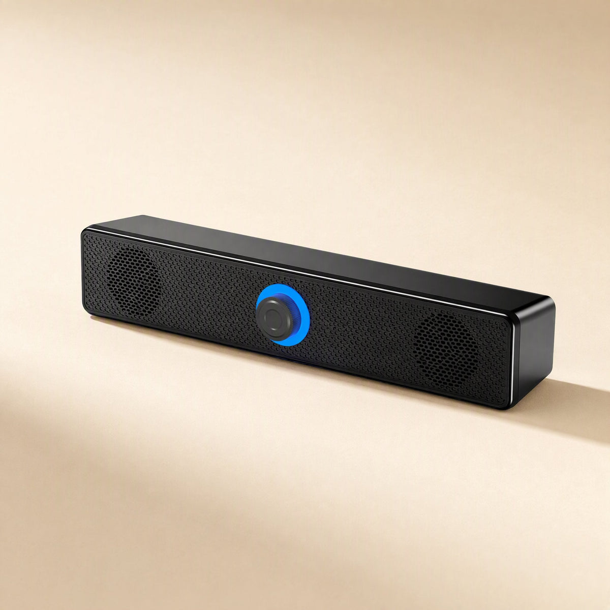 Tinytone – Black bar speaker seen from the right at an angle, with a blue-lit knob and two circular speaker grilles