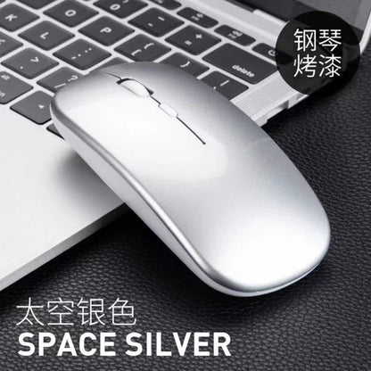 Optiglide Wireless Optical Mouse – silver glossy wireless mouse resting on a laptop keyboard, labeled Space Silver