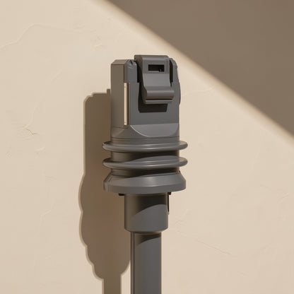 Databraid – Front view of a gray RJ-45 plug with latch tab and ribbed boot, standing upright against a beige wall