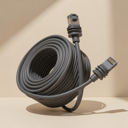 Databraid – Dark gray cable coiled in a wide loop with an RJ-45 plug at each end, on a cream surface in soft light
