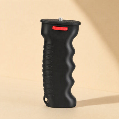 Steadyshot – Side view of the black plastic grip showing ribbed back, finger grooves and strap hole at the base