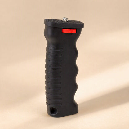 Steadyshot – Angled three-quarter view of the grip with threaded screw top, red dial and textured ridges