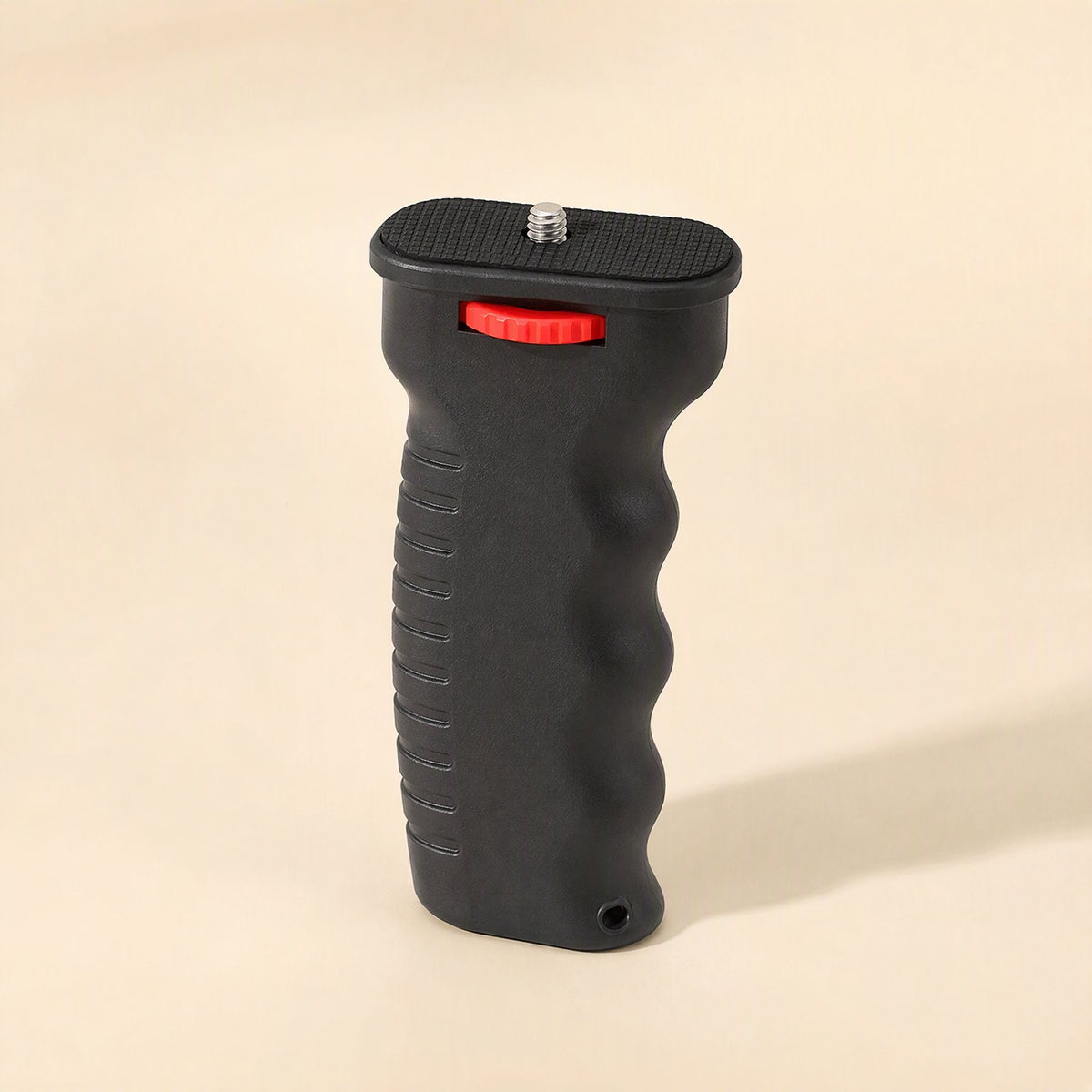 Steadyshot – Top-angled view showing the screw mount plate, red knob and small hole at the bottom of the grip