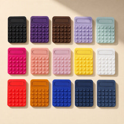 Suctionnest – Fifteen silicone suction cup phone holders in rows of assorted colours, flat lay