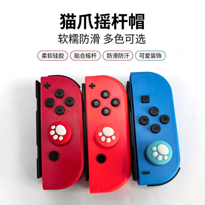 Pawcap – Red and blue Joy-Con controllers fitted with cat paw joystick caps in red and light blue