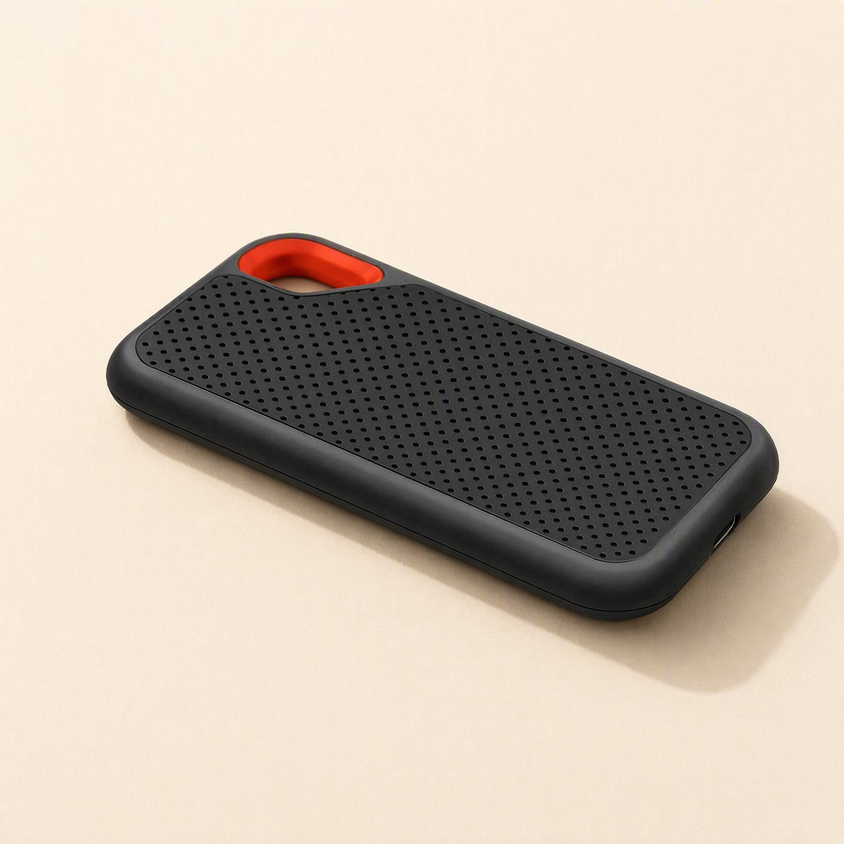 Roamdisk – Drive lying flat at an angle, with orange loop at top left and USB-C port on the right end