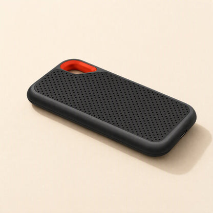 Roamdisk – Drive lying flat at an angle, with orange loop at top left and USB-C port on the right end