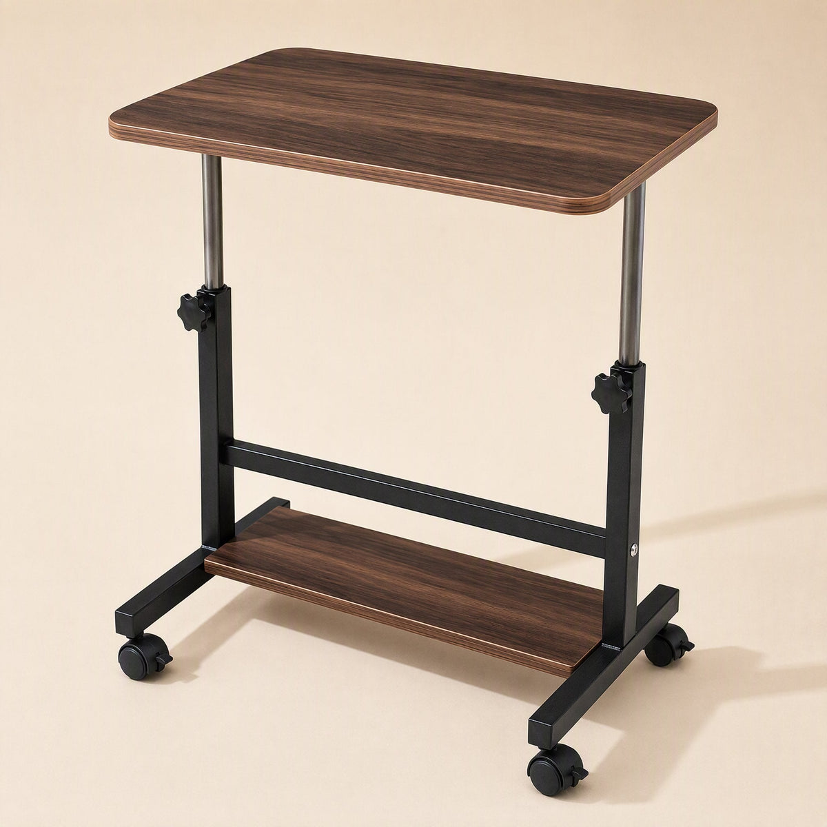 Rollrise – Walnut desk with a single lower shelf, side view showing chrome height-adjustment posts and locking knobs