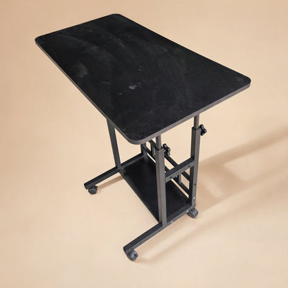 Rollrise – Black-top desk on black frame with casters and lower shelf, high angle view showing the matte surface