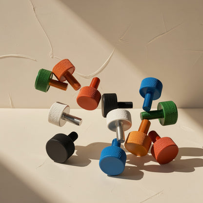 Caseclasp – Assorted colorful knurled screws scattered at various angles, in green, orange, black, white, blue and red