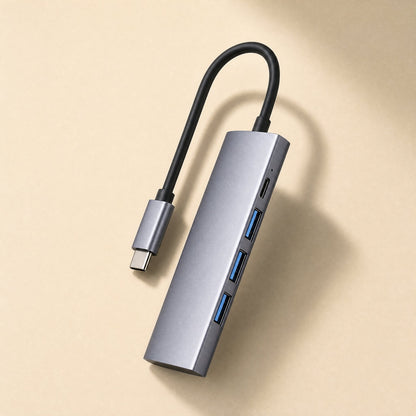 Dockbridge – Gray aluminum hub with three blue USB-A ports and a USB-C port, with its braided cable looped above