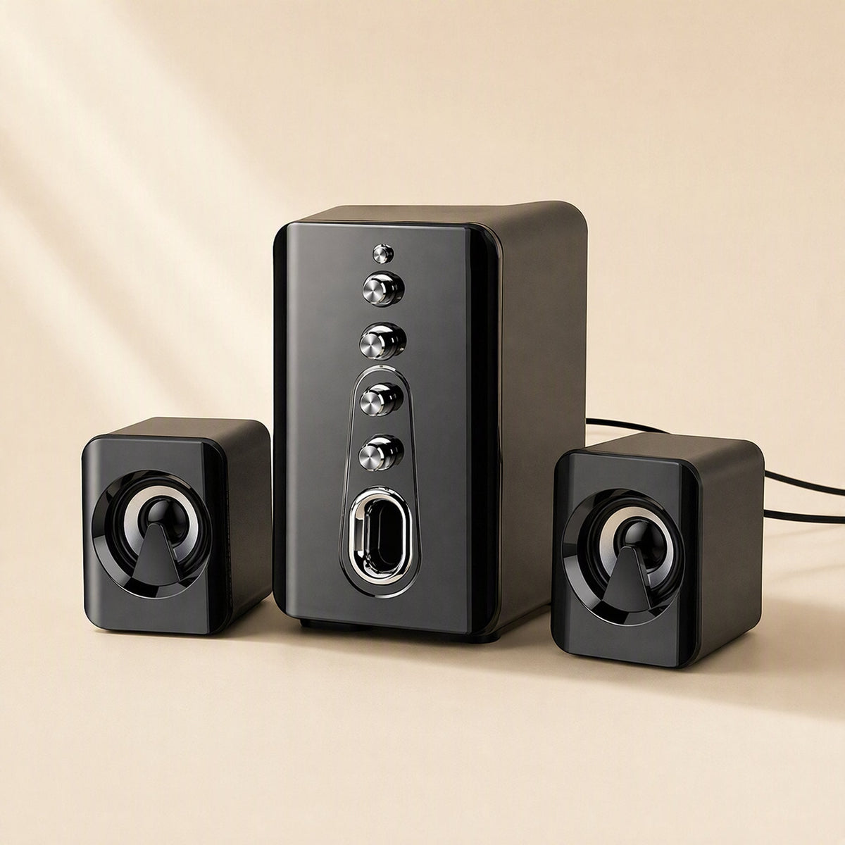 Deskchime – Black three-piece desktop speaker system angled to show the subwoofer's knobs and cables trailing right