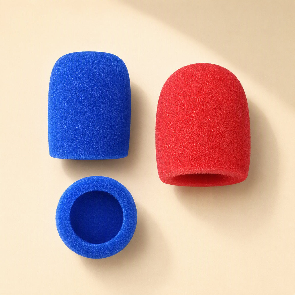 Spongehush – Blue and red foam mic covers shown side by side, with a blue cover seen from above showing its opening