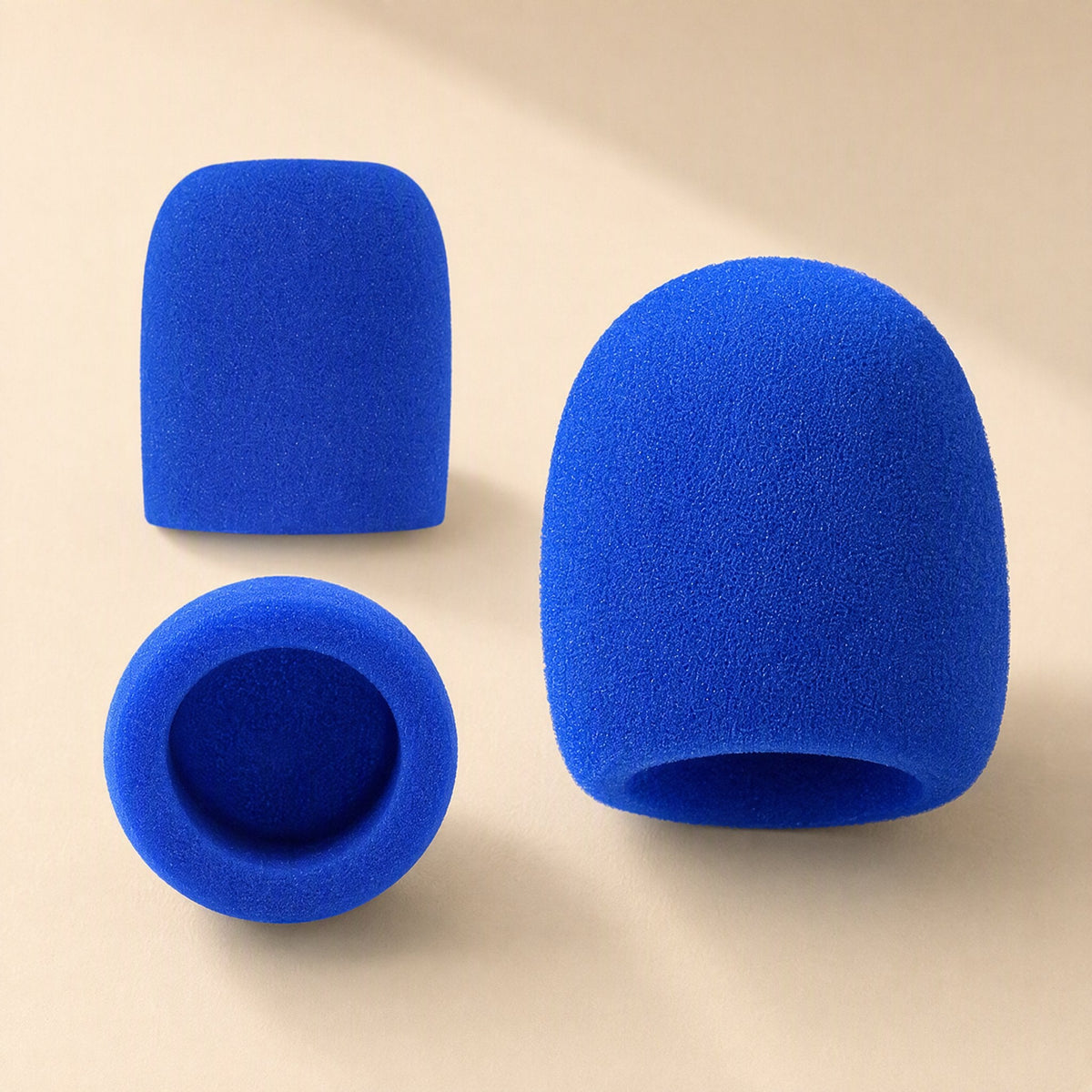 Spongehush Microphone Cover – two blue foam mic covers, one upright and one on its side, with the open end visible