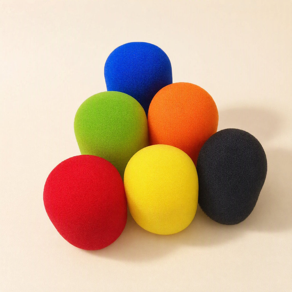 Spongehush Microphone Cover – six foam mic covers in red, yellow, green, orange, blue and black stacked in a pyramid